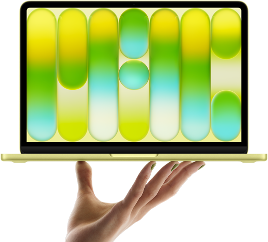 MacBook Neo i farven citrus balancerer på fingerspidserne af en åben hånd, skærmen viser et farverigt abstrakt mønster